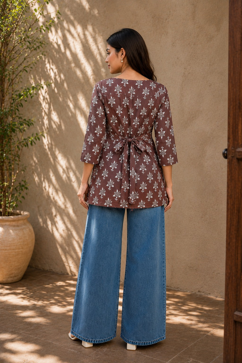 Back view of brown printed rayon tunic for women showing side-tie bow detail