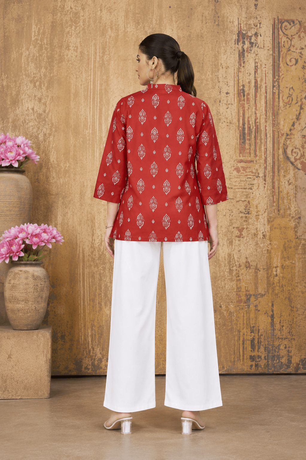 Red printed cotton kurti top for women, back view styled with white pants